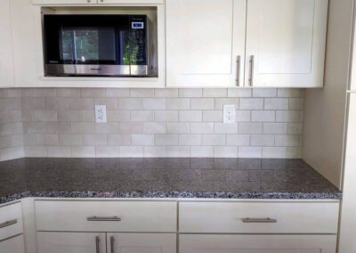 New cabinets, countertop and backsplash lightened up this old dark kitchen with a fresh clean look.
