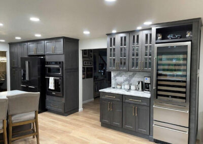 Hall entry into a kitchen with a separate drinks and wine center close to the entertaining space.