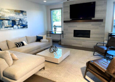 A mix of contemporary and modern furniture and accessories completes this beautiful fireplace and mantel in the living space.